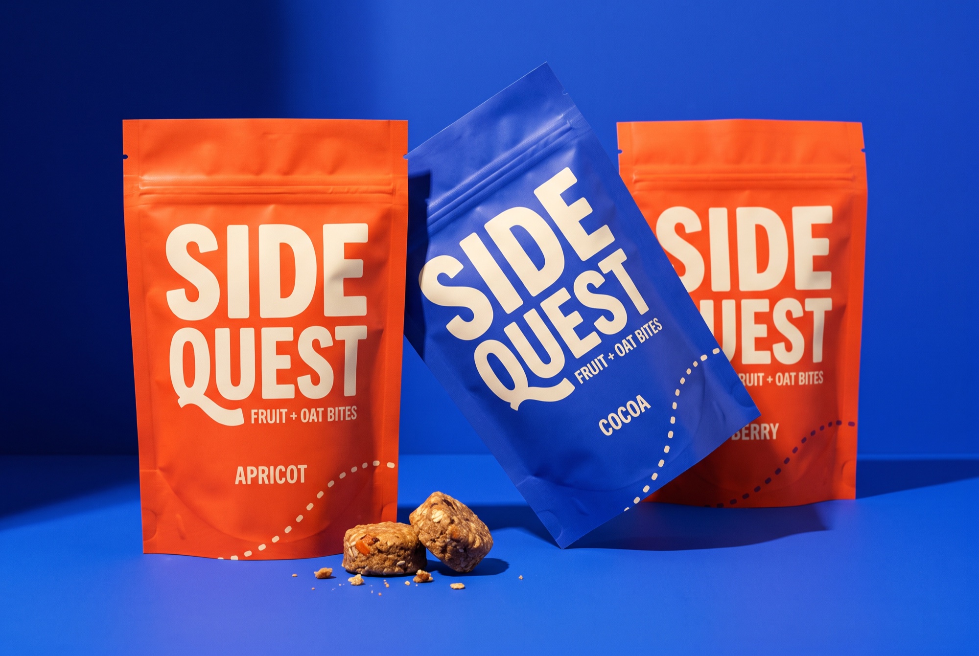 SIDEQUEST orange and cobalt snack pouches with cream lettering and oat bites on a blue studio set.